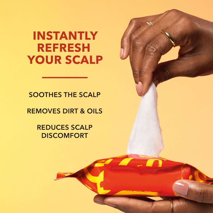 Wemi Ahunamba pulls a wipe out of a package of Creme of Nature Scalp Relief Wipes on a yellow background. The copy on this image reads "Instantly Refresh Your Scalp", followed by "Soothes the Scalp", "Removes Dirt & Oils", and "Reduces Scalp Discomfort".