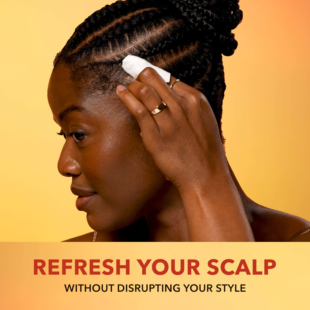 Wemi Ahunamba applying a Scalp Relief Wipe to her scalp with text 'Refresh Your Scalp Without Disrupting Your Style' on a yellow background
